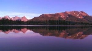 stock-footage-peaceful-lake-with-mountains-reflected-in-the-water