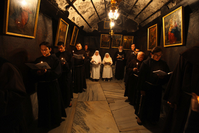 23 Dec 2009, BETHLEHEM, West Bank , ... --- epa01973786 Franciscan monks in the Grotto during prayers at the Church of the Nativity in the biblical West Bank city of Bethlehem on 23 December 2009. Christian pilgrims are preparing to gather in the traditional birthplace of Jesus Christ in the West Bank to celebrate Christmas. EPA/ABED AL HASHLAMOUN --- Image by © ABED AL HASHLAMOUN/epa/Corbis