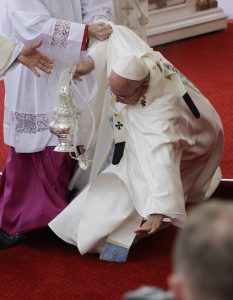 Pope Francis is helped by Vatican Master of Ceremonies, Mons. Guido Marini as he stumbles on the altar as he celebrates a mass in Czestochowa, Poland, Thursday, July 28, 2016. (AP Photo/Gregorio Borgia)